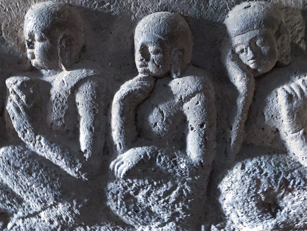 Detail from a carving in stone at the Mahabodhi Temple, Bodh Gaya, of the Buddha's disciples